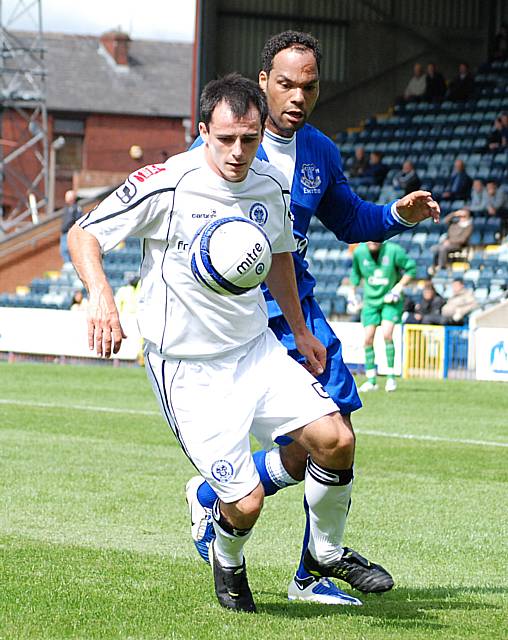 Dagnall comes under pressure from Lescott.