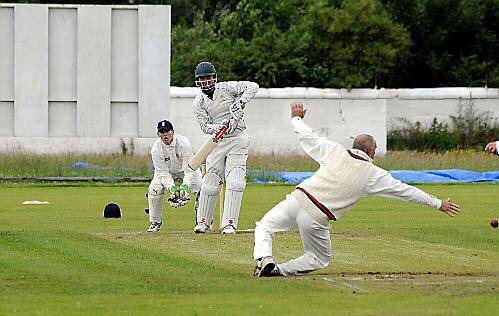 Heywood’s Brendan Taylor slides a shot past the diving Mel Whittle (Oldham).