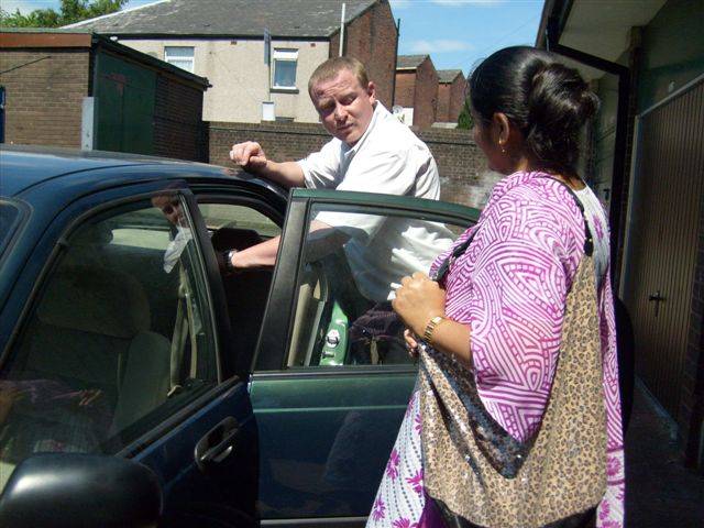 Road Safety Officer, Dave Godley showing one of the Howard Street parents how to fit a car seat.