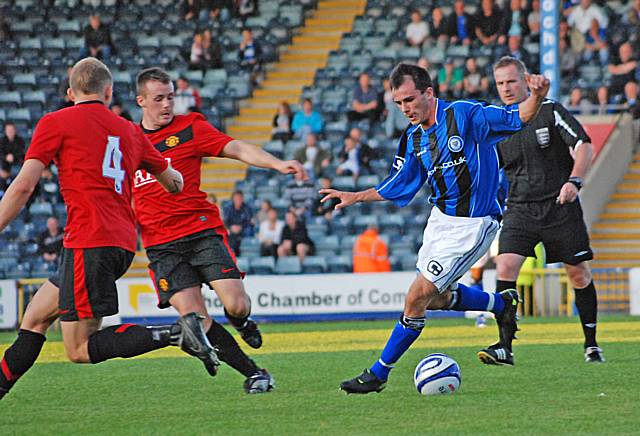 Chris Dagnall drives at the Manchester United defence.