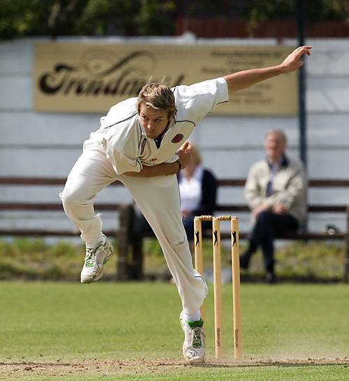 Unsworth overseas amateur Darren Love bowls on his way to a five wicket haul for just 13 runs.