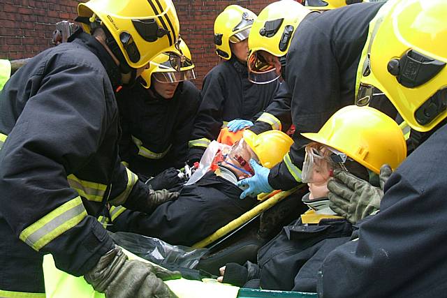 Fire fighters cut the young people out of a car in what could be a real-life situation