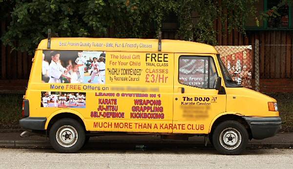 Advert van parked opposite the entrance/exit to Tesco