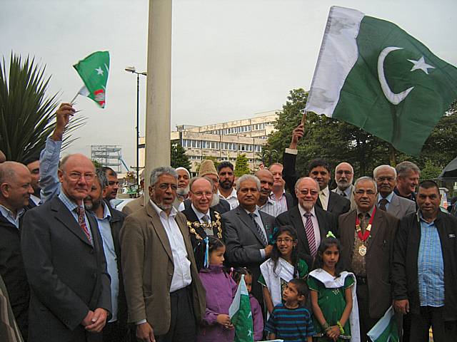 Local dignitaries gather outside the town hall for the raising of the Pakistani flag.