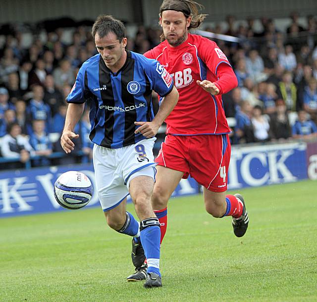 Dagnall keeps the ball away from Chris Blackburn.