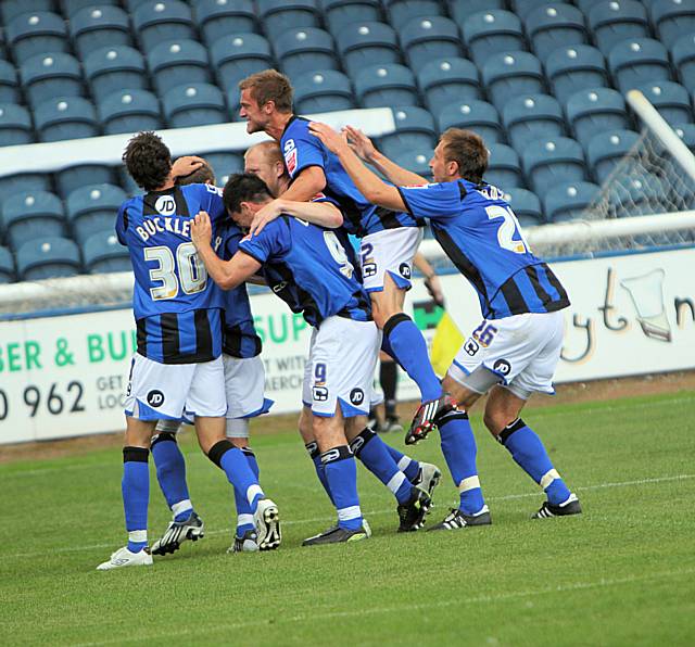 The Dale players celebrate with Tom Kennedy as his spot kick gives Dale their first win of the season.