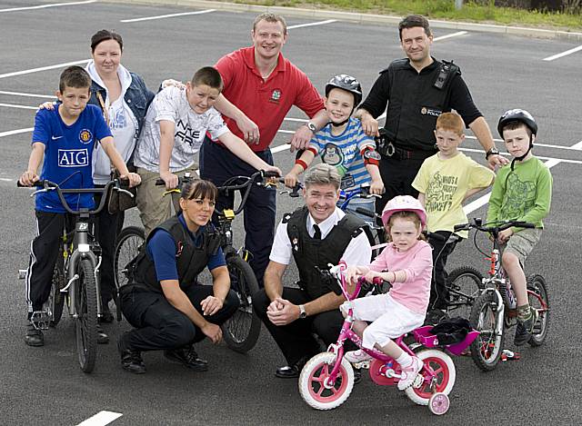 PCSO Dominique Grimes, Chief Superintendent John O’Hare, Dave Godley from Impact Road Safety Unit, resident Anne Mackie and a group of youngsters that took part in the cycle training course.