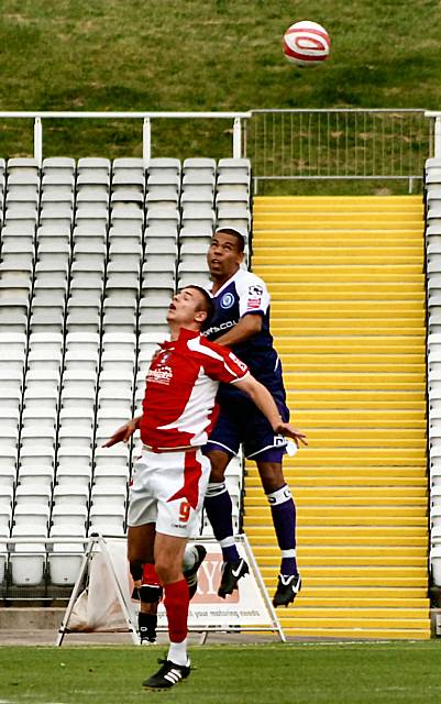 Nathan Stanton goes up for a header with Tom Pope.