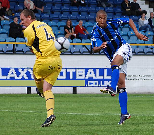 Joe Thompson hits a volley.