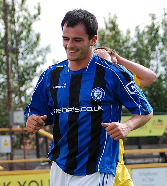 A cheeky grin on the face of Chris Dagnall after the ball loops up off his shoulder and in.