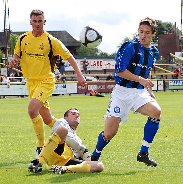 Jon Shaw tangles with the Southport keeper.