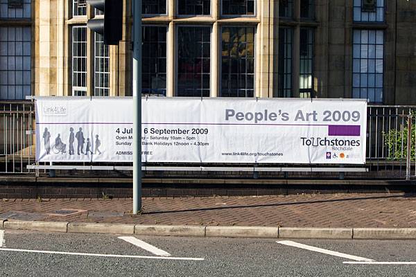 Banner advert on railings outside Touchstones