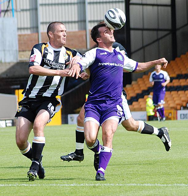 Chris Dagnall keeps the ball away from Owen.