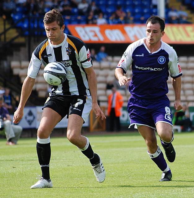 Doug Loft maintains possession under pressure from Dagnall.