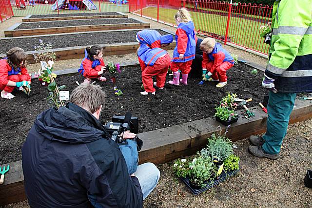 Filming youngsters planting flowers at Darnhill Community Centre.