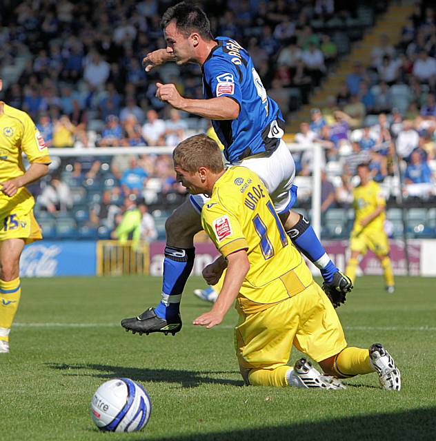 Dagnall evades Wroe's challenge.