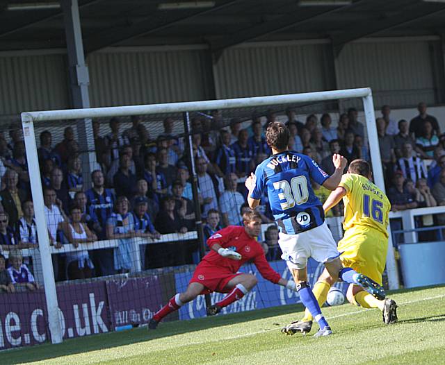 Michael Poke saves Will Buckley's shot but Dagnall is on hand to turn in the rebound.