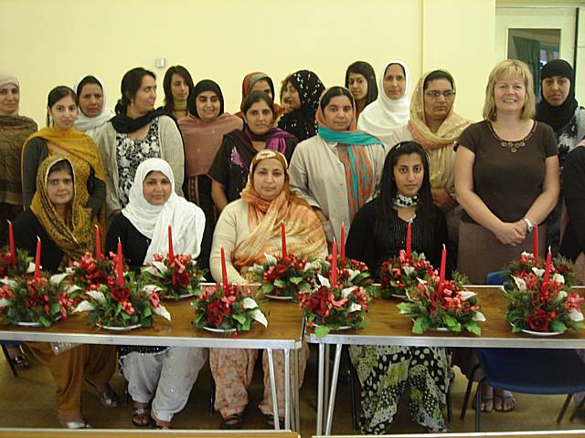 Members of the British Muslim Women’s Health & Fitness Club with Joan Fletcherand their flower arrangements at Deeplish Community Centre.