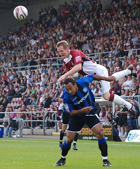 John Curtis clambers over Chris O'Grady to win a header.