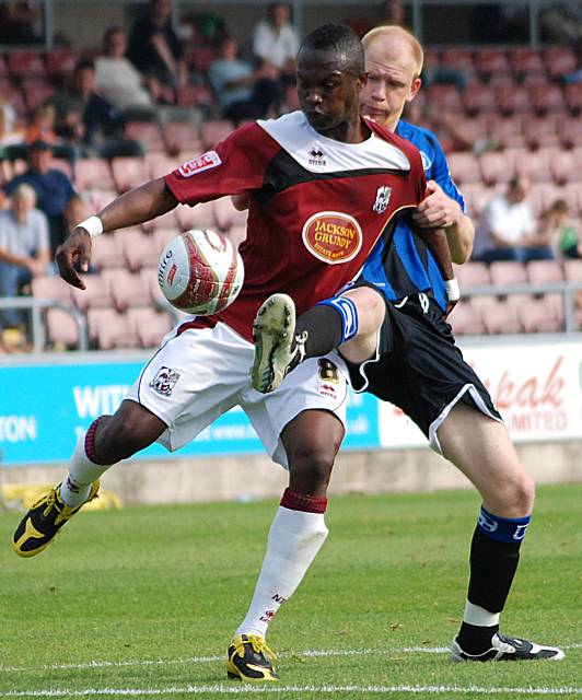 Jason Kennedy looks to nick the ball away from Abdul Osman.