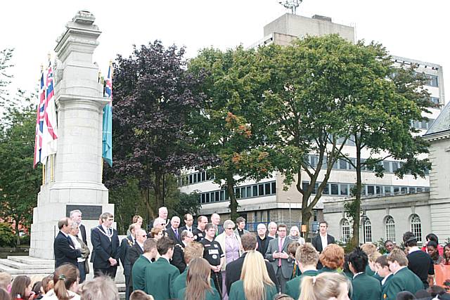 A small crowd and local dignatories gather to commemorate UN Peace Day.