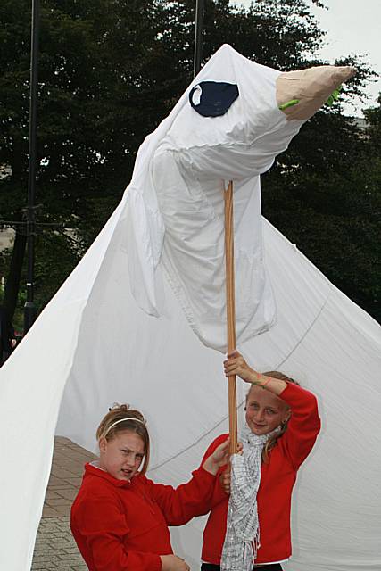 Youngsters hold a dove for peace.