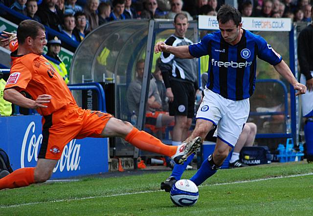 Valentine fires in with a tackle on Dagnall.