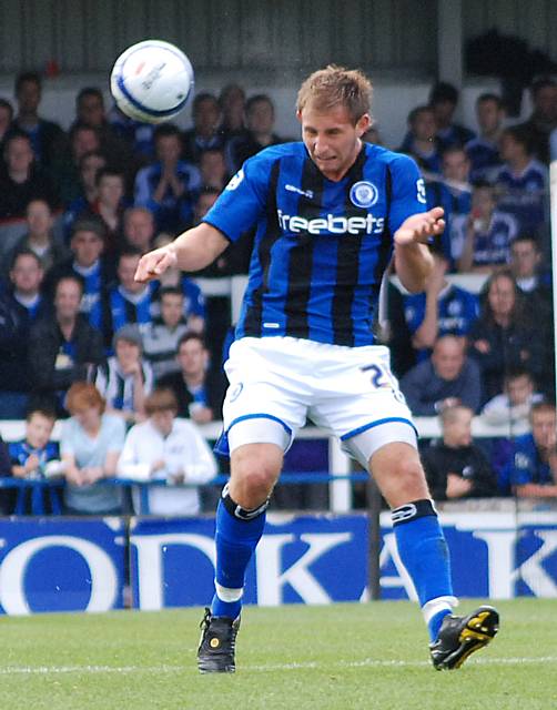 Craig Dawson heads the ball clear.