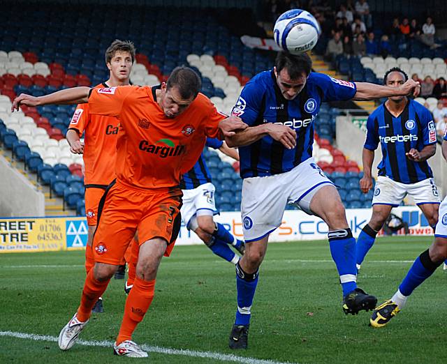 Dagnall gets his head to the ball under pressure from Valentine.