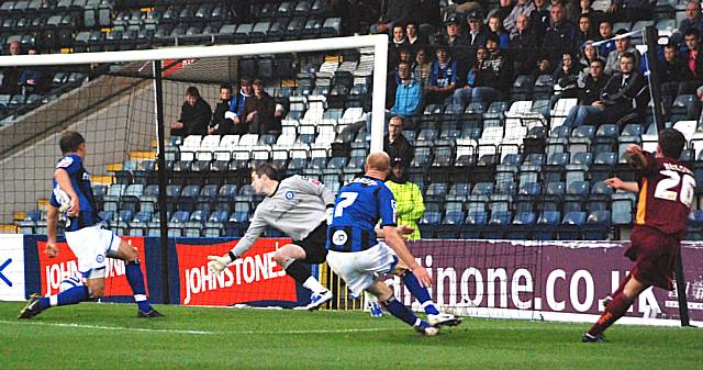 Sam Neilson drills a low shot across the Dale six yard box.