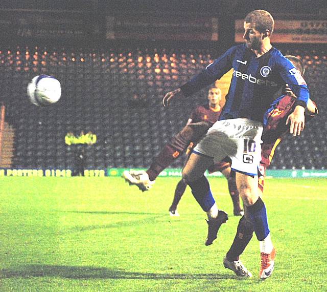 Scott Spencer looks to hold the ball up under pressure from Ramsden.