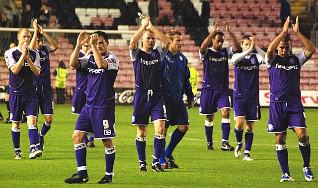 The players show their appreciation to the fans at the final whistle.