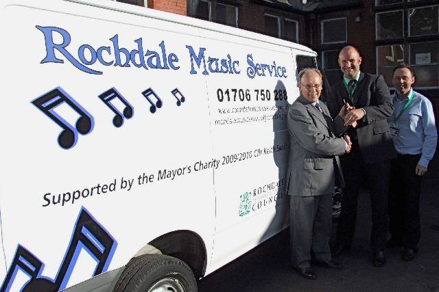 Councillor Keith Swift, Richard Charles and Cliff Woodworth from Rochdale Music Service receive the keys to the new music service van