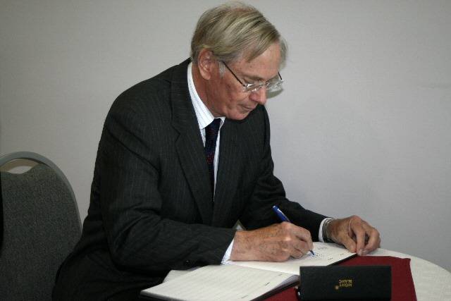 The Duke of Gloucester signing the Heywood Sports Village's visitor's book