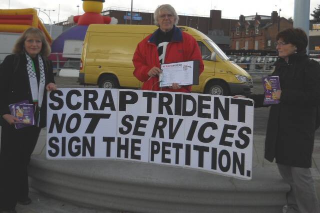 Peace group members, Jenny Turner, Philip Gilligan and Patricia Gilligan with their 'Scrap Trident' placard