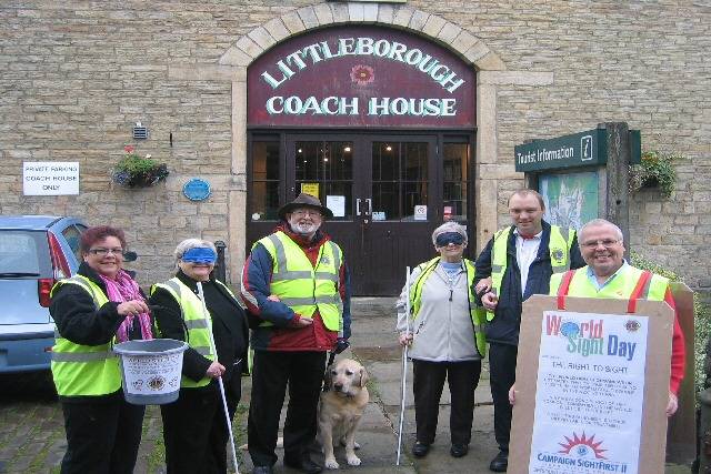 Bobby Moncaster, with spectacle collecting bucket. Pat Mullen, being escorted by Steve Lister and retired guide dog, Magnus. Norah Hawksworth, being escorted by Jamie Rome. Wearing the sandwich boards is Harry Hawksworth
