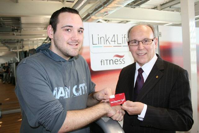 Councillor Keith Swift hands Chris Evans his Link4Life Fitness membership prize