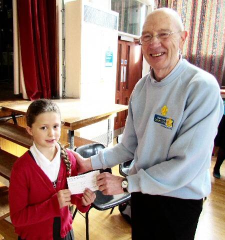 Eleanor Coupe, who collected £200 of the total amount, presenting the cheque to Eddie Holden