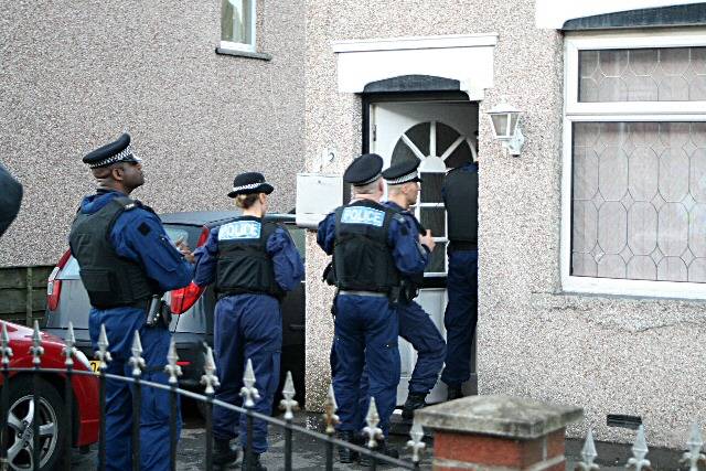 Officers entering a house on Park Road