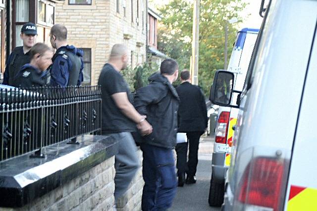 A man being led away by the police following an arrest on Park Road