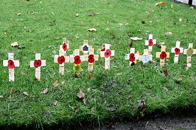 Crosses bearing poppies were placed in the ground