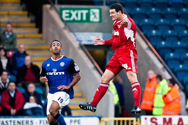 Rochdale 3 - 3 Swindon Town<br />Sean Morrison with a powerful header as Chris O'Grady looks on