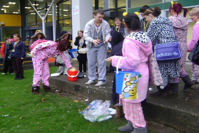 Students throwing wet sponges at tutors