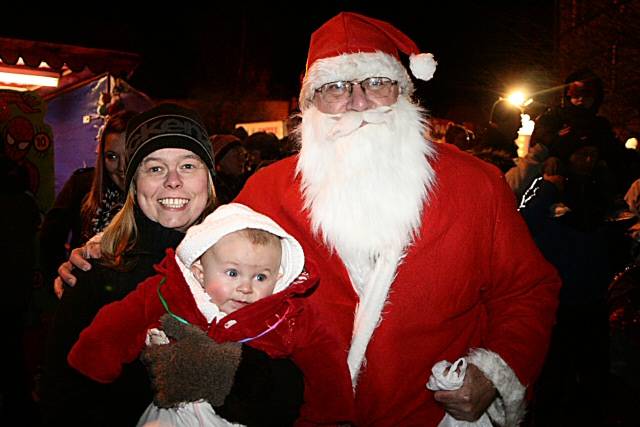 Father Christmas with a young boy and his guardian