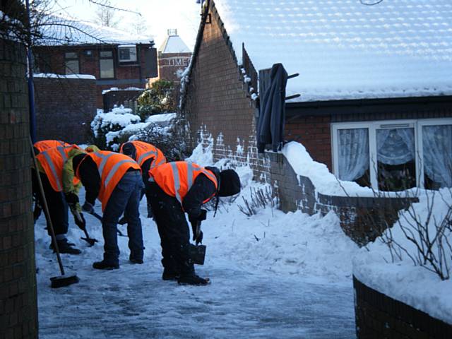 Community payback: Offenders help clear a pathway in Heywood.