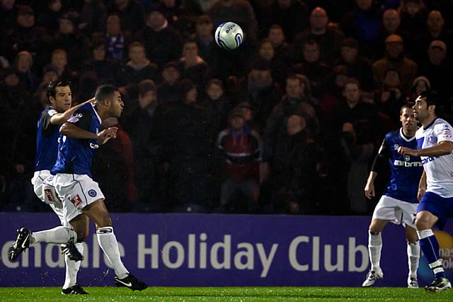 Rochdale v Oldham Athletic – abandoned due to torrential rain rendering the playing surface dangerous - Marcus Holness, watched by Brian Barry-Murphy, heads the ball during a momentary respite from the rain