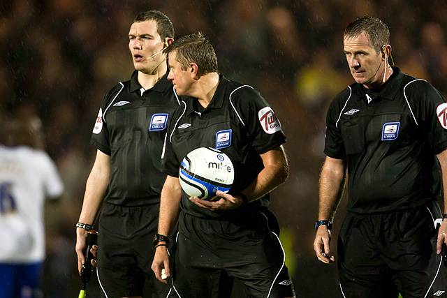 Rochdale v Oldham Athletic – abandoned due to torrential rain rendering the playing surface dangerous - the match officials leave the pitch