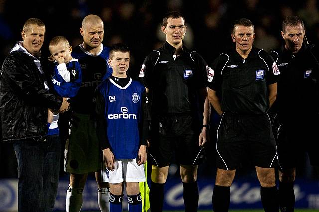 Rochdale v Oldham Athletic – abandoned due to torrential rain rendering the playing surface dangerous - the Dale match mascots line up with the match officials and Dale captain Gary Jones before the kick off