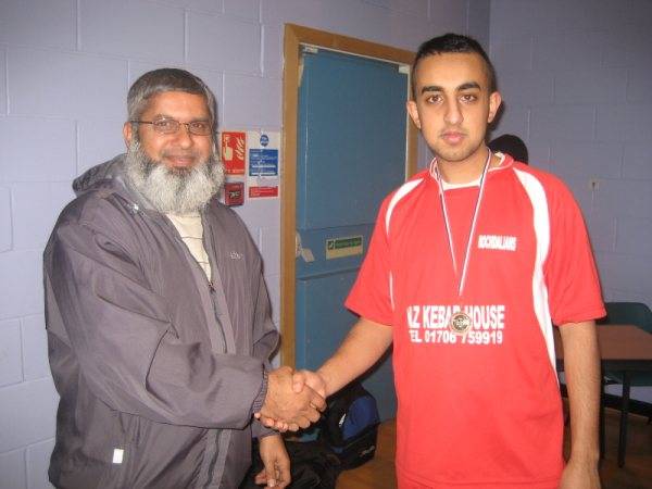 Faisal of Rochdalians receiving his man of the match award from Haji Zafar, committe member of RSCL.