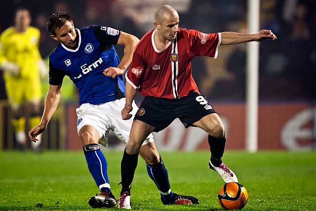 Rochdale v FC United of Manchester - Mike Norton shields the ball from Craig Dawson